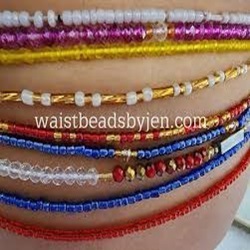 Multiple waistbeads in different colors on a woman's belly